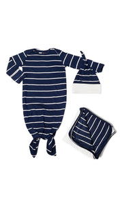 Navy Gown Take Me Home 3-Piece Set. Flat shot of baby gown with hem tied into a knot. Matching knotted baby hat next to gown along with folded swaddle blanket.