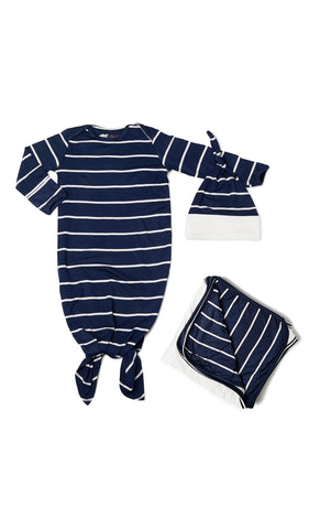 Navy Gown Take Me Home 3-Piece Set. Flat shot of baby gown with hem tied into a knot. Matching knotted baby hat next to gown along with folded swaddle blanket.