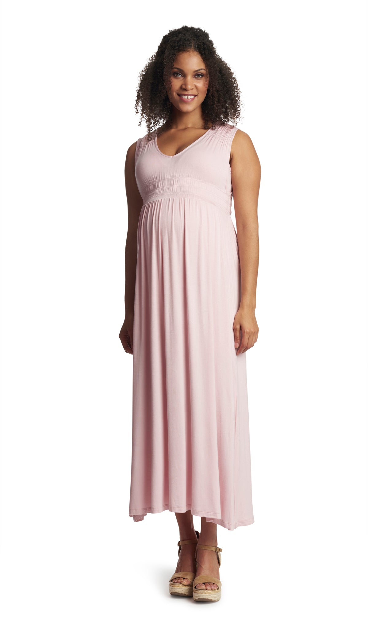 Blush Valeria dress worn by pregnant woman with arms down to side.