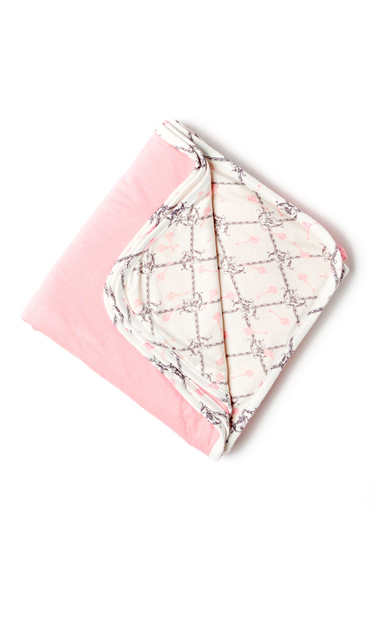 Duchess Swaddle Blanket folded into a square with print showing on one side and reversible contrast solid showing on other side of fold down flap.