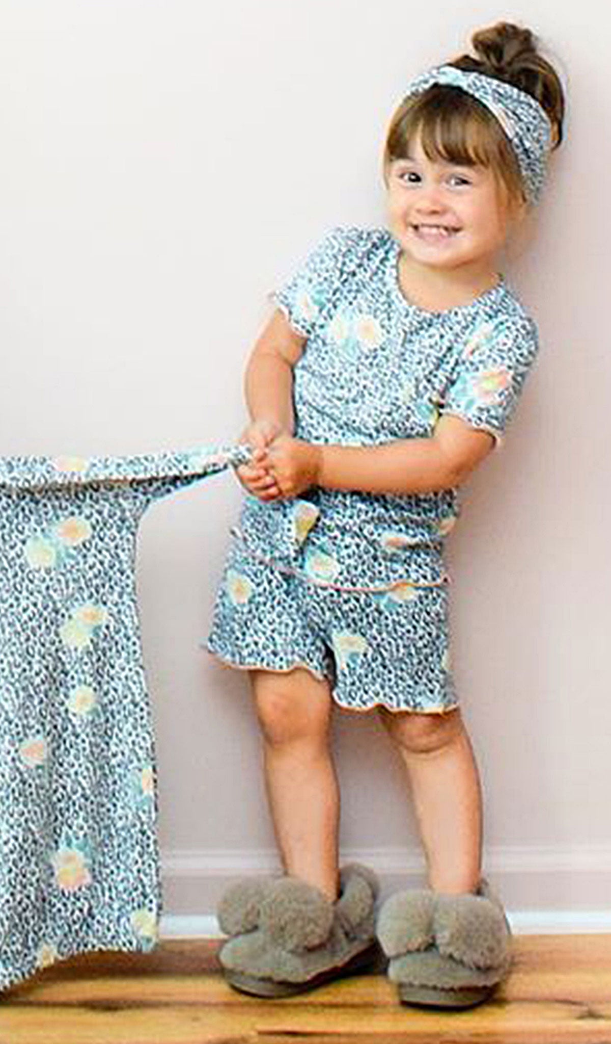 Jungle Floral Bella Kids 3-Piece Short PJ. Little girl tugging on gown sleeve wearing short sleeve top and short with matching headwrap.