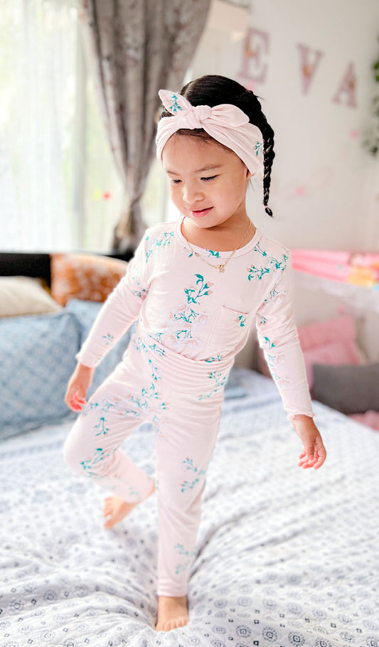 Lily Charlie Kids 3 Piece Pant PJ. Little girl wearing PJs while standing on her bed.
