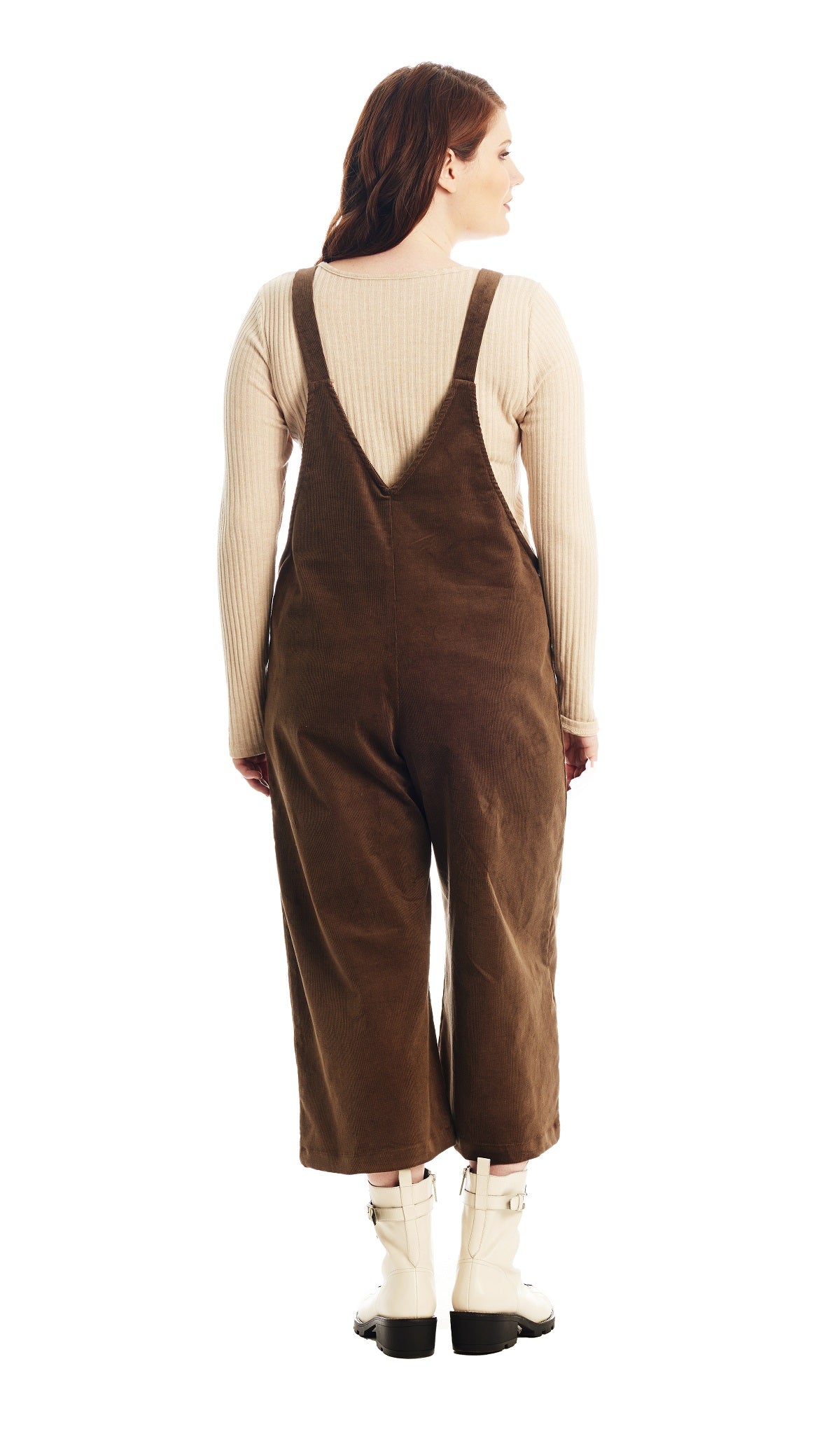 Olive Carlita overall back shot worn by woman with cream boots.