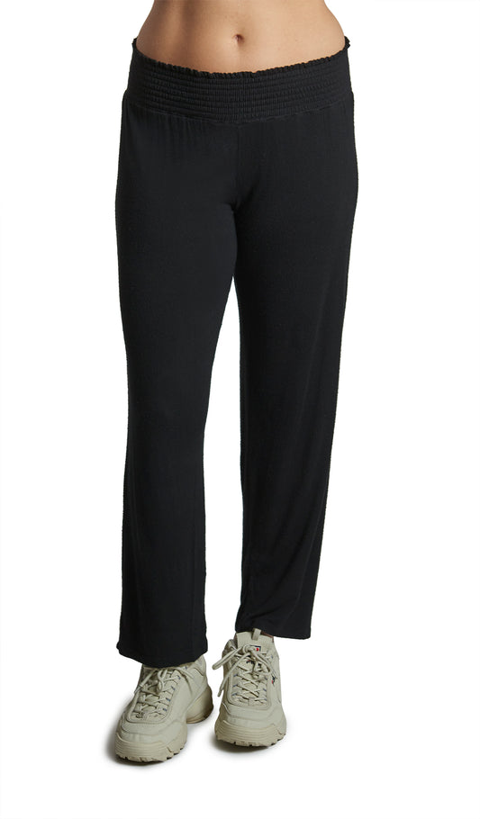 Black Pirlo Pant. Pirlo pant shown waist down on woman wearing with tennis shoes.