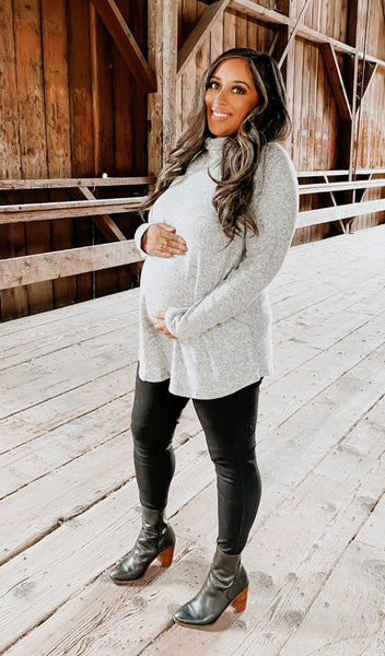Heather Grey Teresa sweater worn by pregnant woman cradling her belly.