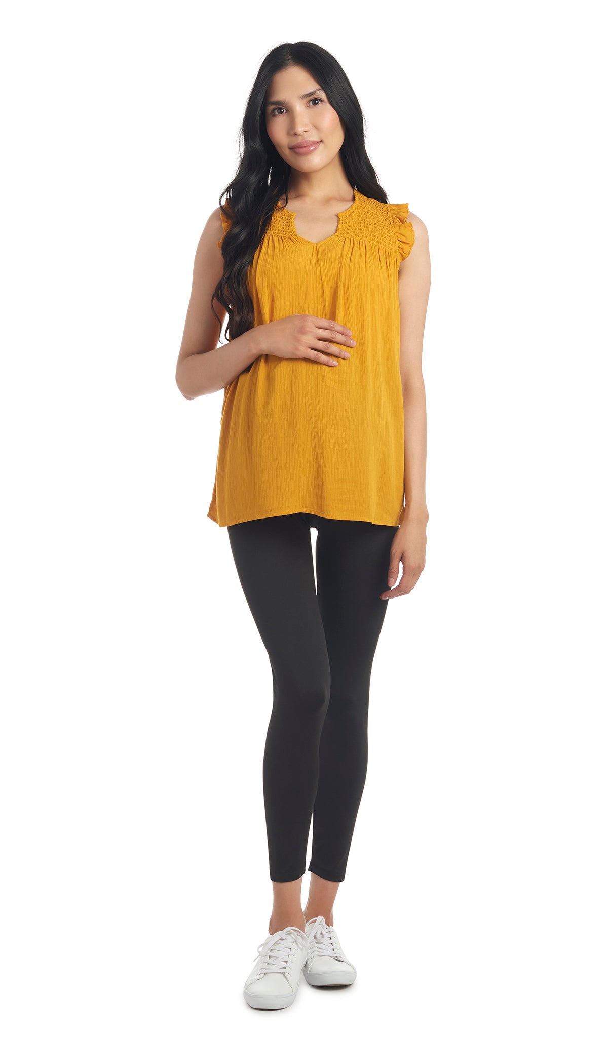 Mustard Koa top full length shot of pregnant woman wearing top with black leggings.
