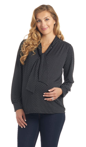 Black Dot Vanessa top worn by pregnant woman with one hand on her belly.