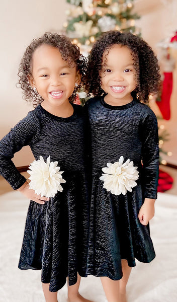 Black Kendyl Kids Twirly Dress. 2 Little girls wearing Kendyl dresses with removeable flower pins on waist.