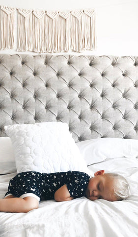 Stars Aydenne Baby 2-Piece Short PJ. Lifestyle shot of boy sleeping on his side in bed wearing Aydenne.