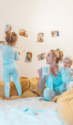 Blue Chantilly Charlie Kids 3-Piece Pant PJ. Woman wearing robe, tank top and pant from matching Analise PJ set, looking at girl and holding baby girl, both wearing matching Charlie pajama sets.
